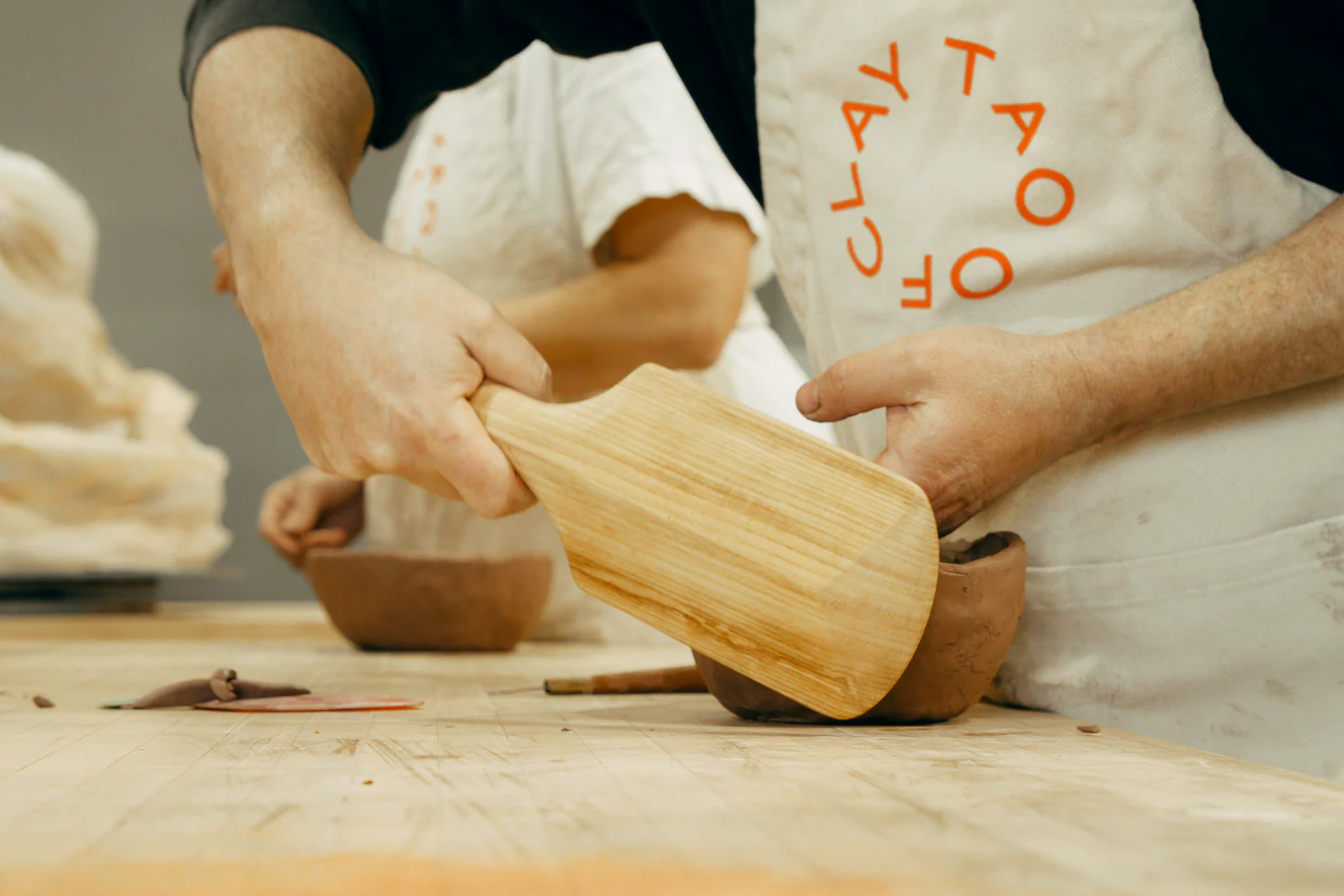 Beginner students working with clay